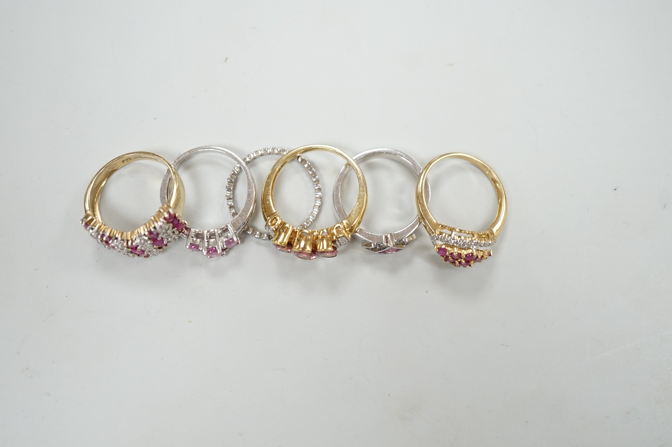 Five assorted modern 9ct gold and gem set dress rings, gross weight 16.7 grams and one other white metal and gem set eternity ring.